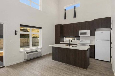 a kitchen with a sink a stove and a refrigerator
